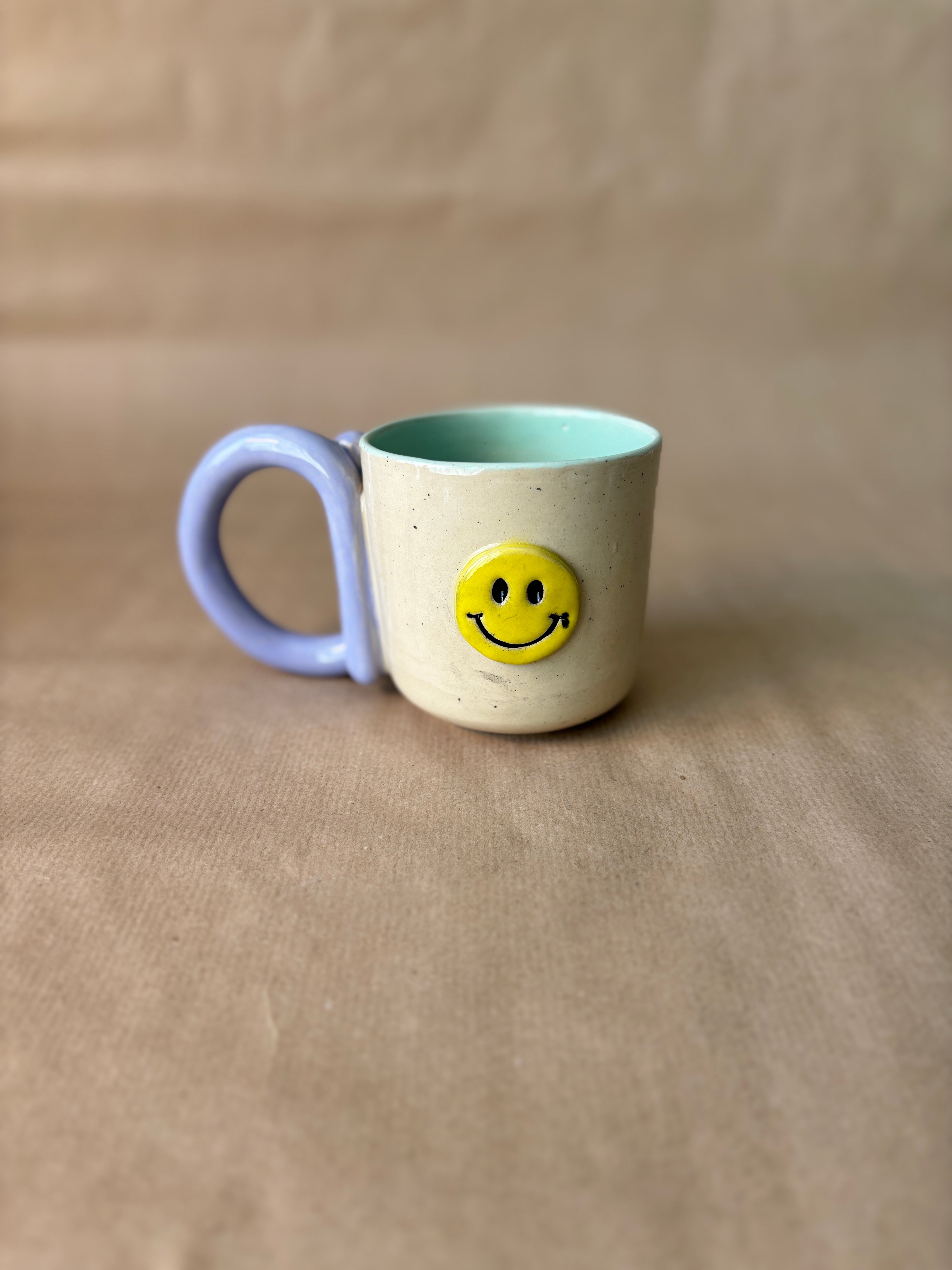 Smiley face mok lila/turqoise